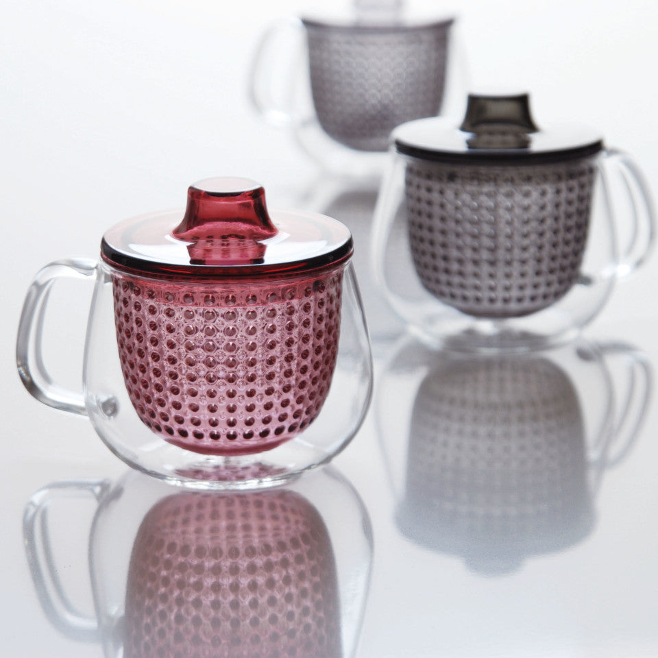 Unimug glass mug with, l-r, red and grey strainer and lid, styled.